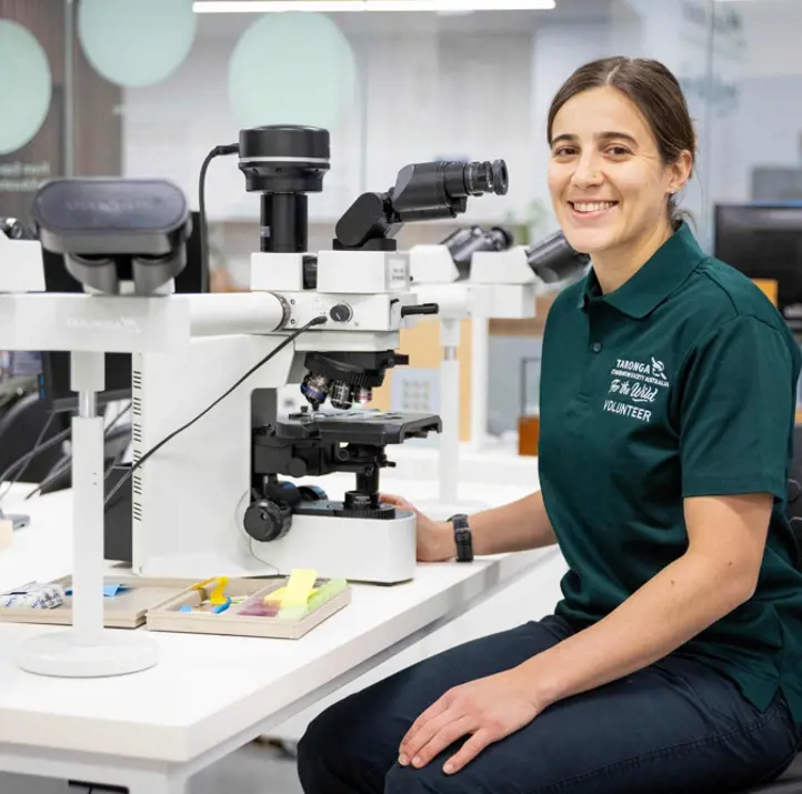 Lab Volunteer sitting at desk with equipment