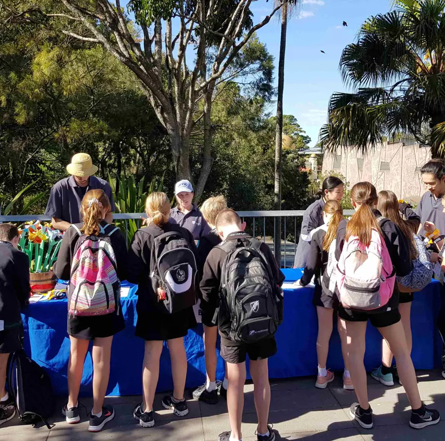 School students participating in an outdoor learning activity during National Science Week at a zoo.