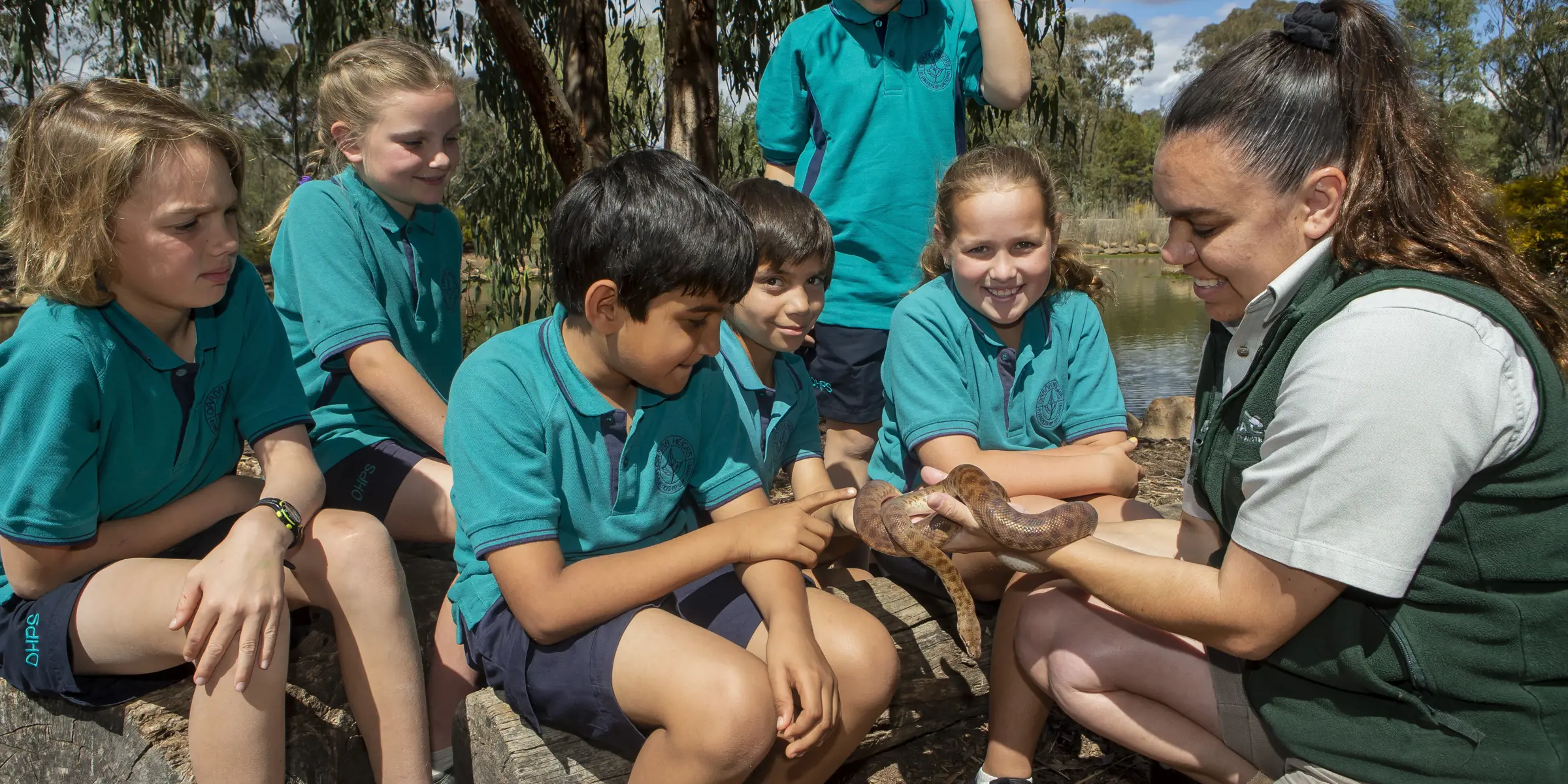 Studens learning about snake with Taronga educator during workshop at Taronga Western Plains Zoo in Dubbo