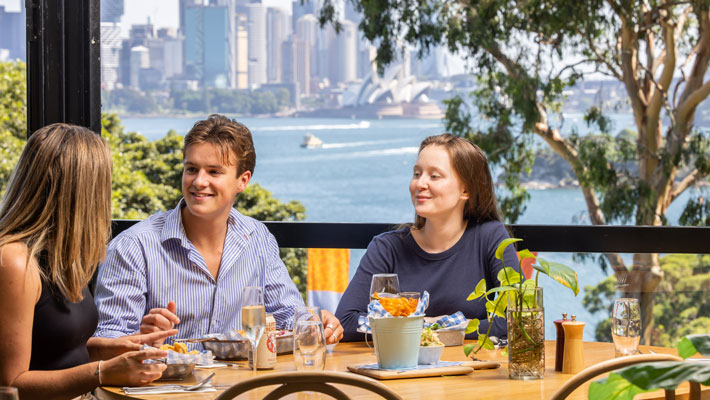 Guests enjoying a delicious seafood feast with scenic Harbour views
