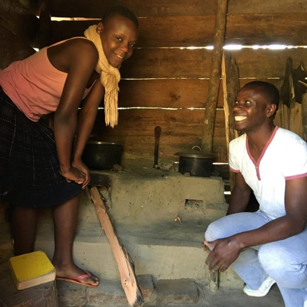 A family in Uganda standing next to their new fuel efficient stove 2018. Photo: New nature foundation