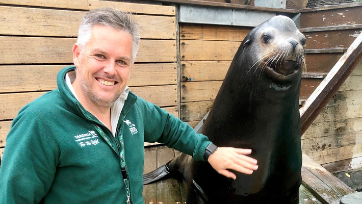 Taronga's Director of Education, Paul Maguire, with a Sea-lion at Taronga Zoo Sydney.